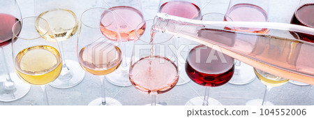 Rose wine poured into a glass at a tasting panorama. Rose, red, and white wine 104552006