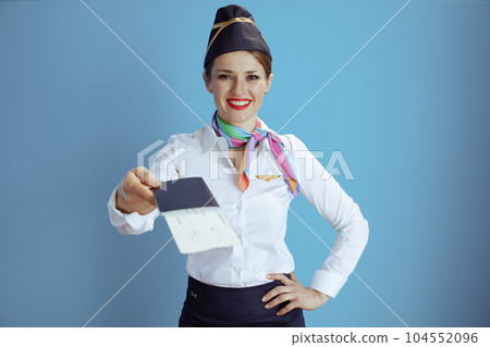 smiling stylish air hostess woman on blue 104552096
