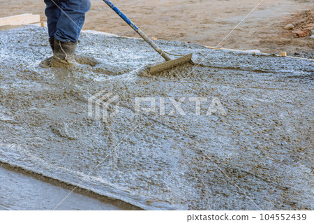 Workers had to work quickly during the pouring of concrete to avoid any delays. Workers had to work quickly during the pouring of concrete to avoid any delays. 104552439