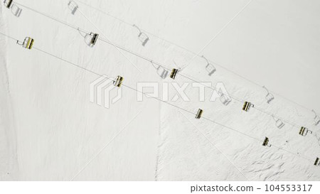 Aerial view of Livigno ski resort in Lombardy, Italy. Chairlifts, ski lifts, gondola cabin lifts moving. View from above Aerial view of Livigno ski resort in Lombardy, Italy. Chairlifts, ski lifts, gondola cabin lifts moving. View from above 104553317