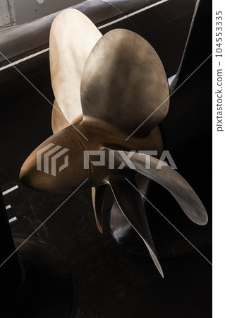 Shiny submarine propeller, close up vertical photo 104553335
