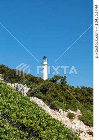 Lefkada island lighthouse on sea shore green cliff 104553744