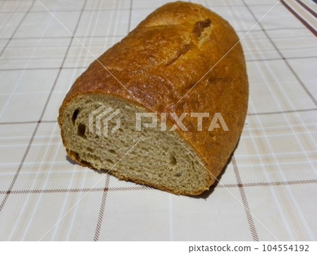Loaf of gray bread on the tablecloth Loaf of gray bread on the tablecloth 104554192