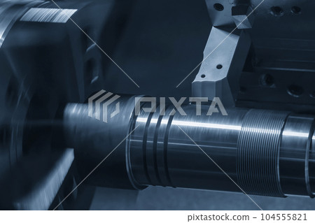 The CNC lathe machine forming cutting the metal shaft parts. The CNC lathe machine forming cutting the metal shaft parts. 104555821