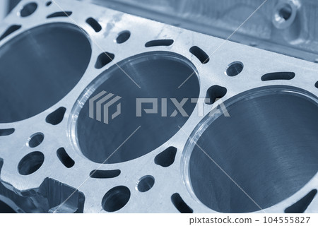 Close up scene the aluminum cylinder block in the light blue. Close up scene the aluminum cylinder block in the light blue. 104555827