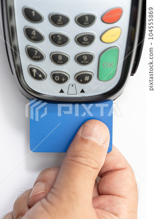 Hand put Credit card into payment terminal on white background Hand put Credit card into payment terminal on white background 104555869