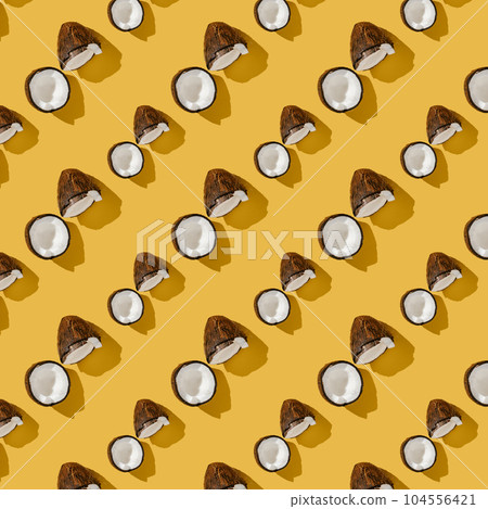 A pattern of coconuts on a bright yellow background. 104556421
