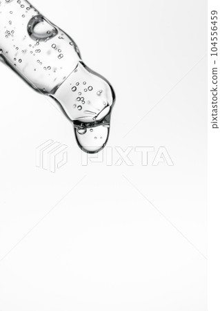 Transparent pipette with cosmetics on a white isolated background. 104556459