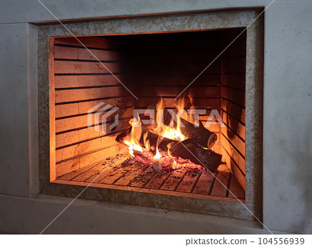 Soothing setting by a cabin fireplace Soothing setting by a cabin fireplace 104556939