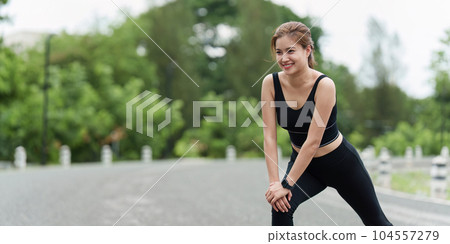 Healthy Asian woman is warm up before jogging. Fitness girl running. Female exercising at outdoor park 104557279
