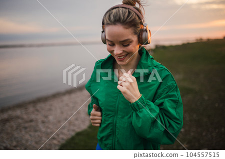 Young woman runing outdoor, near the lake. 104557515