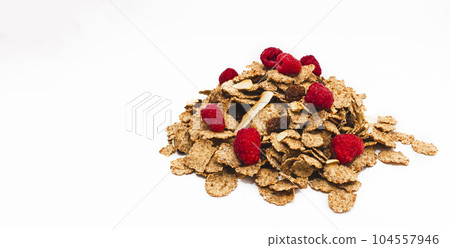 Muesli from various cereals with raspberries, raisins, coconut on a white background Muesli from various cereals with raspberries, raisins, coconut on a white background 104557946