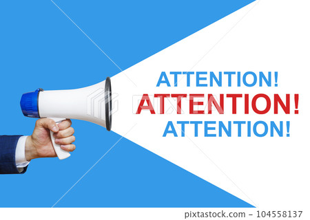 A hand is holding a megaphone with speech bubble ATTENTION A hand is holding a megaphone with speech bubble ATTENTION 104558137
