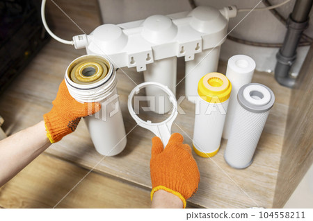Plumber installs or change water filter. Replacement aqua filter 104558211
