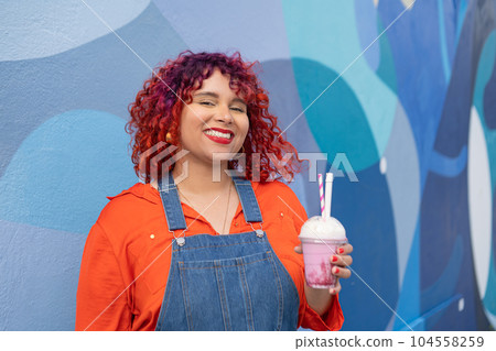 Young adult femele holding milk cocktail 104558259