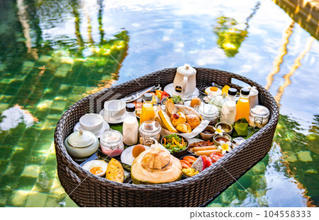 Floating breakfast in pool in Lamai beach resort in Koh Samui, Thailand Floating breakfast in pool in Lamai beach resort in Koh Samui, Thailand 104558333