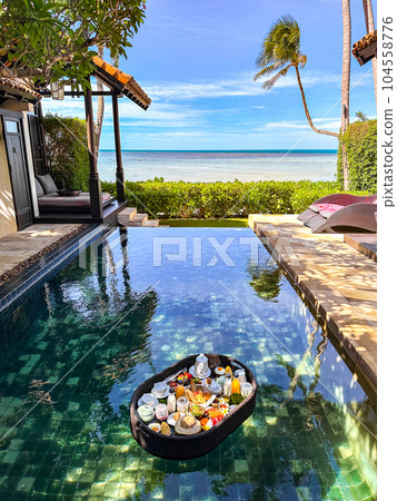 Floating breakfast in pool in Lamai beach resort in Koh Samui, Thailand Floating breakfast in pool in Lamai beach resort in Koh Samui, Thailand 104558776