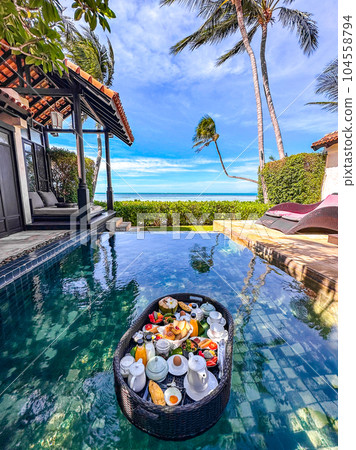 Floating breakfast in pool in Lamai beach resort in Koh Samui, Thailand Floating breakfast in pool in Lamai beach resort in Koh Samui, Thailand 104558794