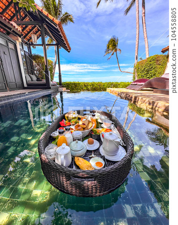 Floating breakfast in pool in Lamai beach resort in Koh Samui, Thailand Floating breakfast in pool in Lamai beach resort in Koh Samui, Thailand 104558805