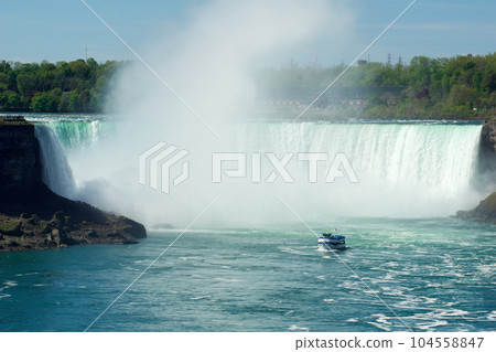 NIAGARA FALLS, ONTARIO, CANADA - MAY 20th 2018: Touristic boat on Horseshoe Falls, also known as Canadian Falls 104558847