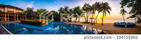 Beachfront sunrise with pool and palm trees in Hua Hin, Prachuap Khiri Khan, Thailand Beachfront sunrise with pool and palm trees in Hua Hin, Prachuap Khiri Khan, Thailand 104558968