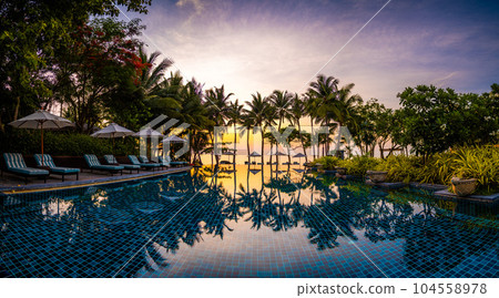Beachfront sunrise with pool and palm trees in Hua Hin, Prachuap Khiri Khan, Thailand 104558978