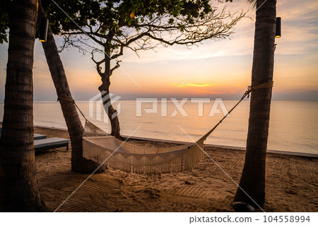 Beachfront sunrise with pool and palm trees in Hua Hin, Prachuap Khiri Khan, Thailand Beachfront sunrise with pool and palm trees in Hua Hin, Prachuap Khiri Khan, Thailand 104558994