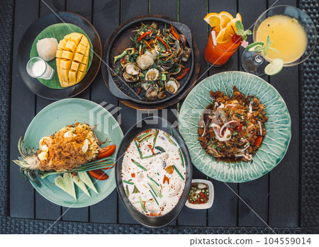 Thai food dishes in a restaurant beachfront in Hua Hin, Thailand Thai food dishes in a restaurant beachfront in Hua Hin, Thailand 104559014