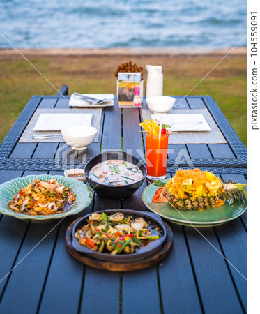 Thai food dishes in a restaurant beachfront in Hua Hin, Thailand 104559091
