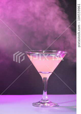 Glass with a drink on a background of smoke waves. Glass with a drink on a background of smoke waves. 104559961