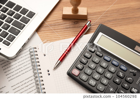 Business report preparing with calculator on desk Business report preparing with calculator on desk 104560298
