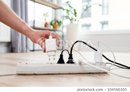 Electrical plug in outlet socket at home Electrical plug in outlet socket at home 104560305