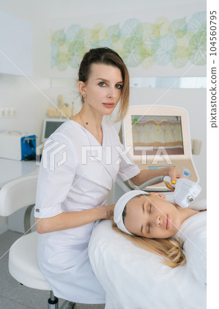 Vertical portrait of beautician doctor using laser machines and ultrasound SMAS lifting to rejuvenate skin in beauty clinic. Concept of non-surgery cosmetology, professional skincare, beauty treatment Vertical portrait of beautician doctor using laser machines and ultrasound SMAS lifting to rejuvenate skin in beauty clinic. Concept of non-surgery cosmetology, professional skincare, beauty treatment 104560795