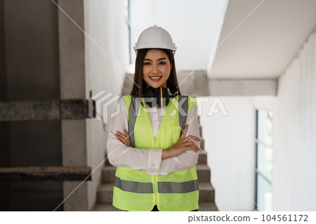 woman smile with multi ethnic engineer brainstorming and measuring for cost estimating on blueprint and floor plan drawings about design architectural and engineering for houses and buildings. 104561172