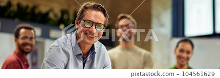 Group of young successful multi ethnic business team looking at camera and smiling while having a meeting in the modern office and coworking space 104561629
