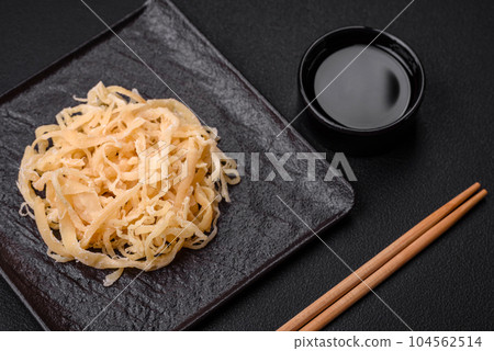 Delicious dried squid in the form of shavings with salt and spices 104562514