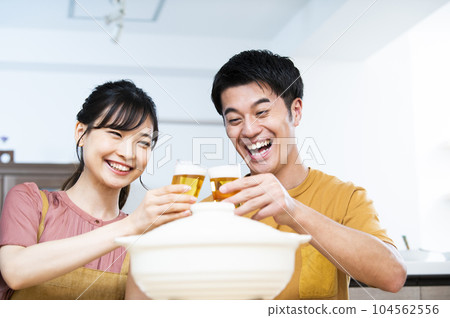 Young couple toasting with beer Young couple toasting with beer 104562556
