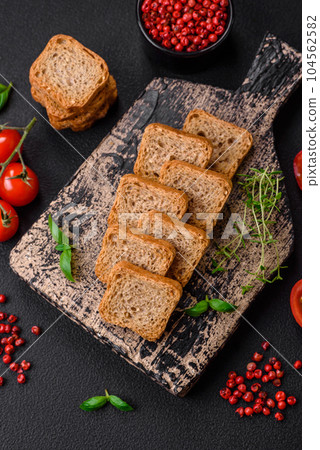 Delicious salted rectangular wheat croutons with salt and spices 104562582