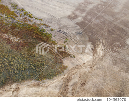a rural road winding through a landscape of lush green vegetation a rural road winding through a landscape of lush green vegetation 104563078