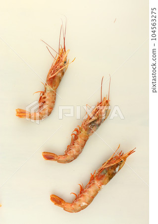 frosted king prawns closeup photo on white table background frosted king prawns closeup photo on white table background 104563275