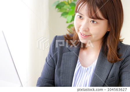 A young woman who works hard at her desk A young woman who works hard at her desk 104563627