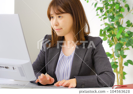 A young woman who works hard at her desk A young woman who works hard at her desk 104563628