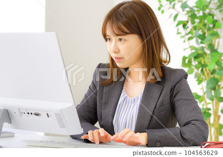 A young woman who works hard at her desk A young woman who works hard at her desk 104563629