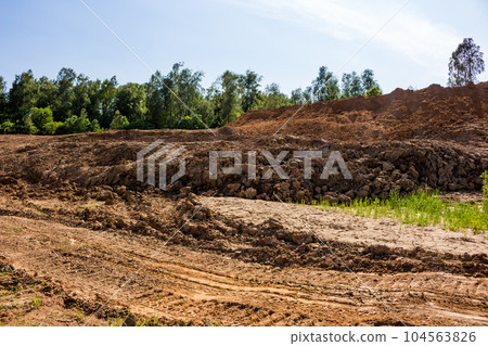 Excavated earth with heaps of clay soil Excavated earth with heaps of clay soil 104563826