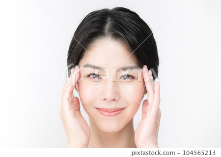 A beauty woman who cares about the corners of her eyes and cheeks looking at the camera A beauty woman who cares about the corners of her eyes and cheeks looking at the camera 104565213
