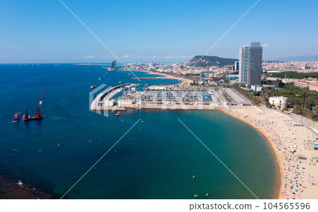 Barcelona cityscape on Mediterranean coast overlooking Olympic Harbour Barcelona cityscape on Mediterranean coast overlooking Olympic Harbour 104565596