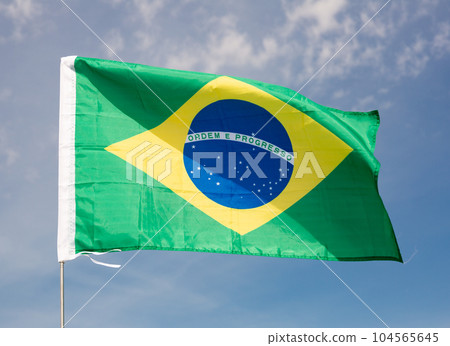 Brazil flag waving against blue sky Brazil flag waving against blue sky 104565645