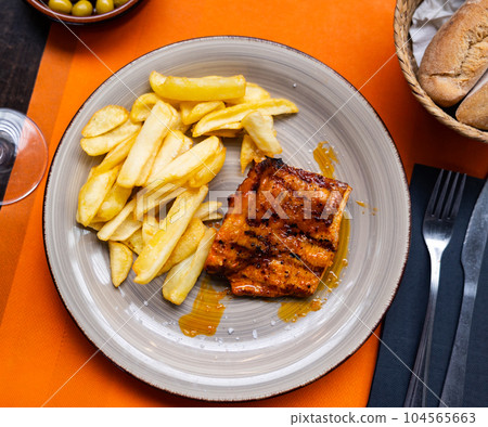 Tasty grilled pork meat with boiled potatoes served on table Tasty grilled pork meat with boiled potatoes served on table 104565663