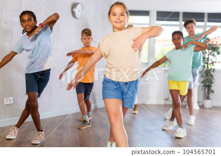 Girl performs choreographic exercises and teaches energetic mobile social dance hip hop with friends Girl performs choreographic exercises and teaches energetic mobile social dance hip hop with friends 104565701