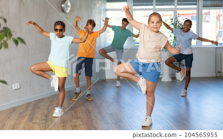 Energetic tween girl krumper dancing with group of children in studio 104565955
